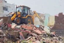 Hydra bulldozers clear debris near partially demolished homes along Hyderabad's Musi Riverbed, sparking renewed fears among residents.