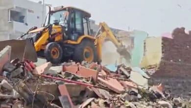 Hydra bulldozers clear debris near partially demolished homes along Hyderabad's Musi Riverbed, sparking renewed fears among residents.