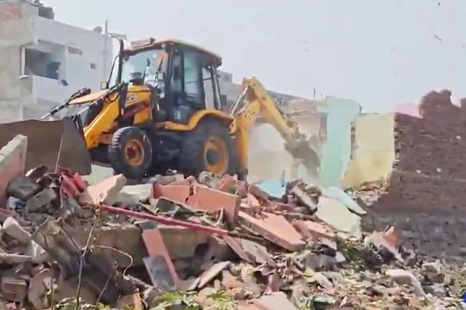 Hydra bulldozers clear debris near partially demolished homes along Hyderabad's Musi Riverbed, sparking renewed fears among residents.